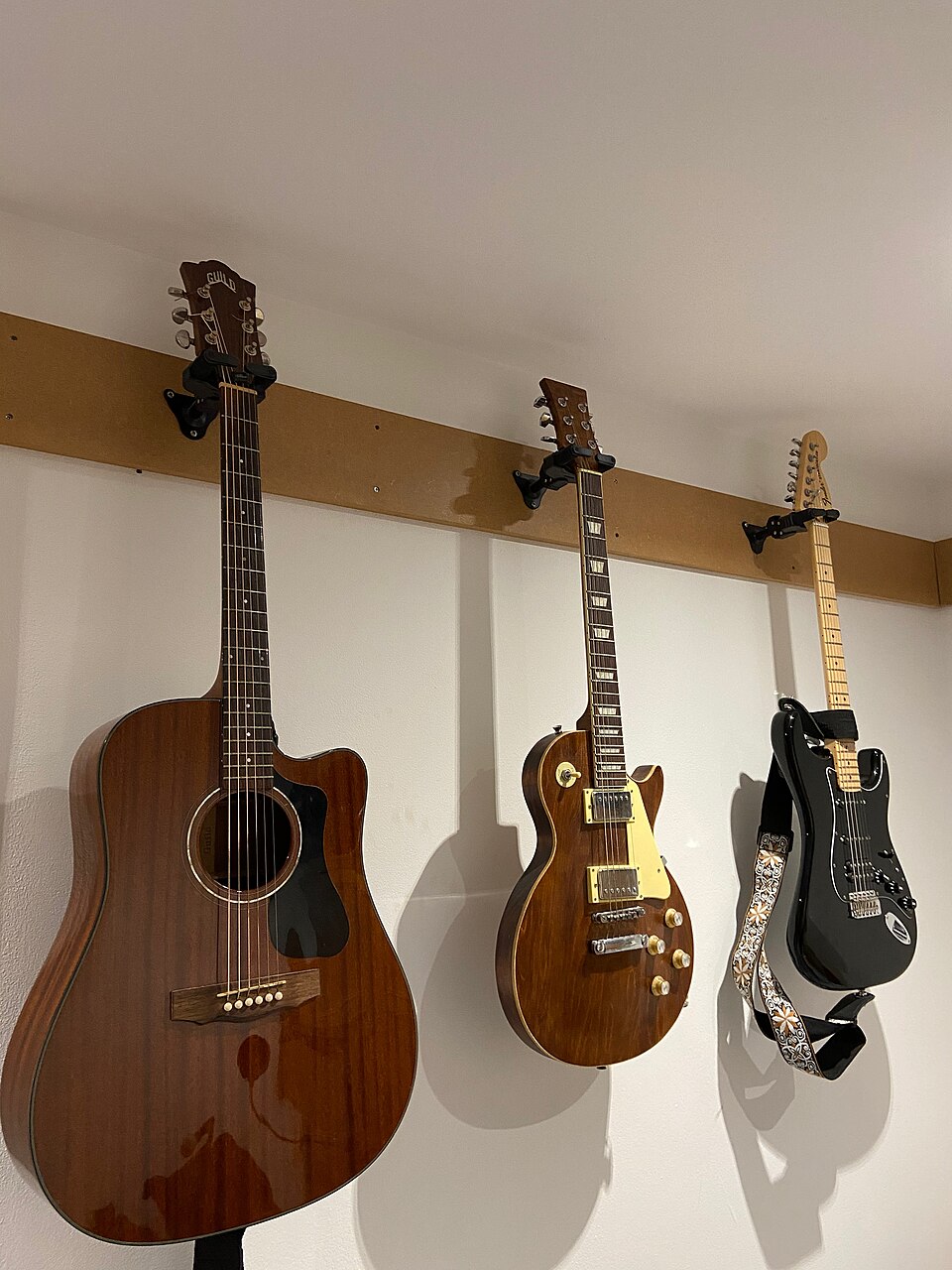 An electro-acoustic Guild D-120, a custom Les Paul design guitar and a Fender American Special Stratocaster.jpg